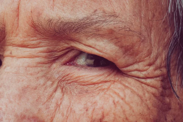 Senior woman's eye with filter effect retro vintage style — Stock Photo, Image