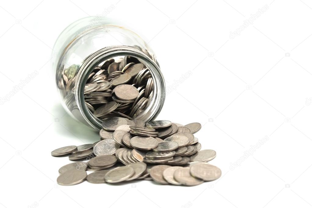 Jar of thai coins spilled on a white background