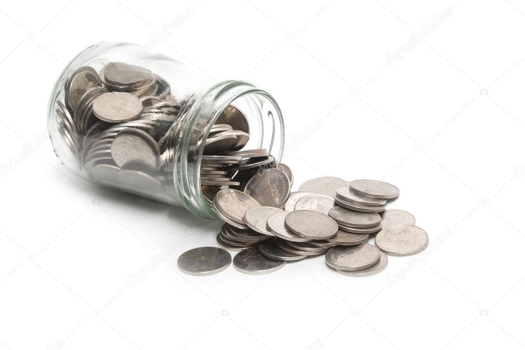 Jar of thai coins spilled on a white background