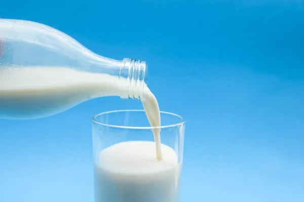 With milk on blue background — Stock Photo, Image