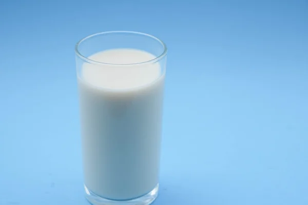 With milk on blue background — Stock Photo, Image