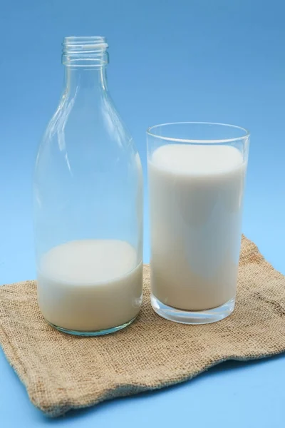 With milk on blue background — Stock Photo, Image
