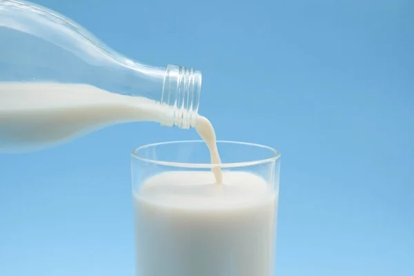 With milk on blue background — Stock Photo, Image