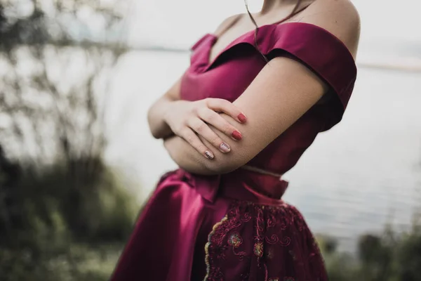 Junge schlanke Mädchen in elegantem Abendkleid aus Burgund und festlicher Seide — Stockfoto