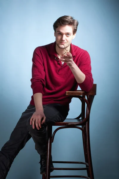 Young Man sitting on chair — Stock Photo, Image