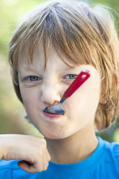 Pojken äta utomhus — Stockfoto