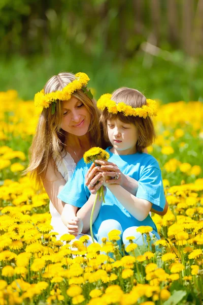 Mother and son in Dandelion Field — Stock Photo, Image