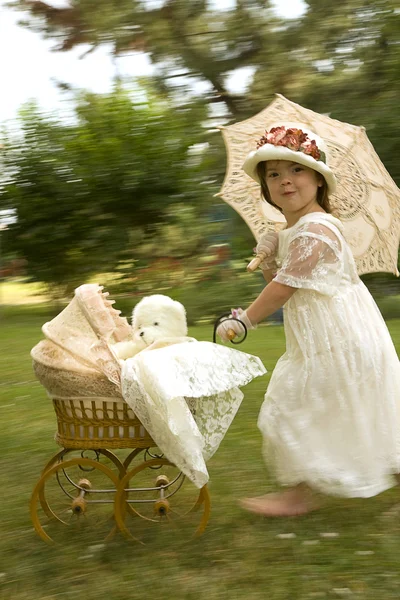 Vintage - Girl with doll buggy — Stock Photo, Image