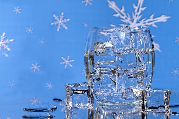 Glass of Ice Water - Snowfalke background — Stock Photo, Image