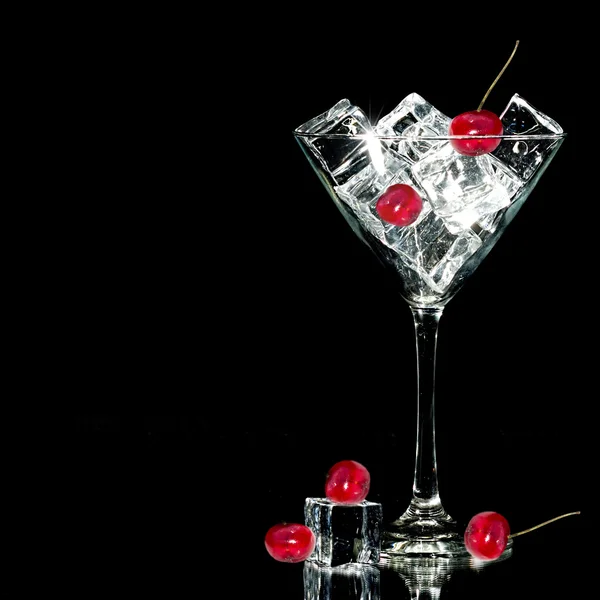 Ice and cherries in Cocktail Glass Isolated on black — Stock Photo, Image