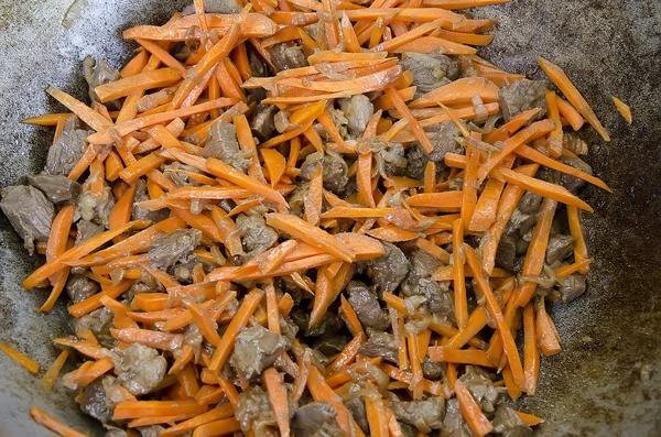 Cuts of beef and carrot stewed in a cauldron — Stock Photo, Image