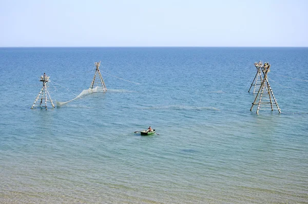 Pescador en un barco revisando redes de pesca — Foto de Stock