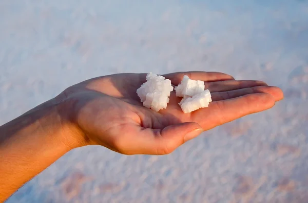 Salt crystals in female hand — Stock Photo, Image