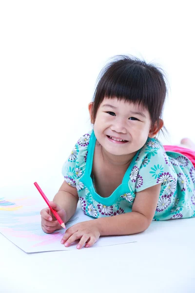 Child lie on the floor drawing on paper and smiling.  On white Stock Photo