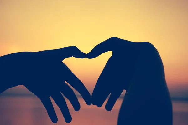 Love shape hand silhouette on sky background. — Stock Photo, Image