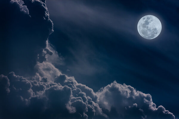 Attractive photo of a nighttime sky with clouds, bright full moon would make a great background. Nightly sky with large moon. Beautiful nature background. Outdoors.
