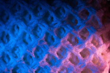 Yumuşak yumuşak tekstilin yakın çekimi. Arkaplan için örgü dokusuna sahip soyut kumaş.