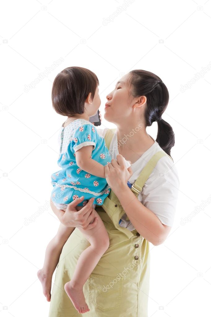 Asian mother carrying and soothe her daughter on white backgroun