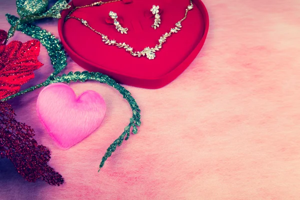 Pink heart-shaped and jewelry in red velvet box — Stock Photo, Image