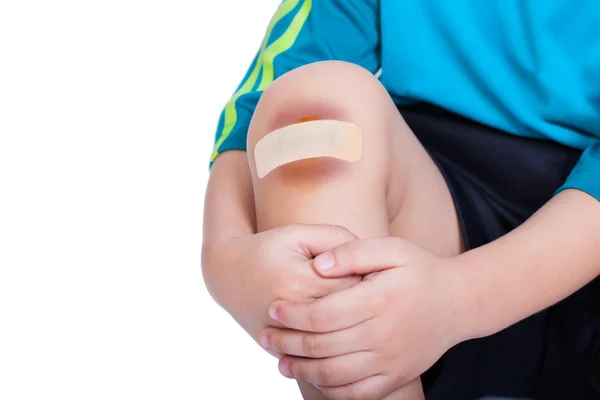 Child knee with a plaster (for wounds) and bruise — Stock Photo, Image