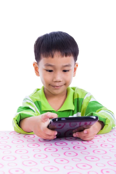 Kleine Aziatische (thai) jongen met behulp van digitale Tablet PC aan balie — Stockfoto