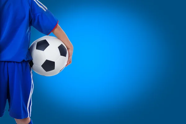 Back view of youth soccer player in blue uniform