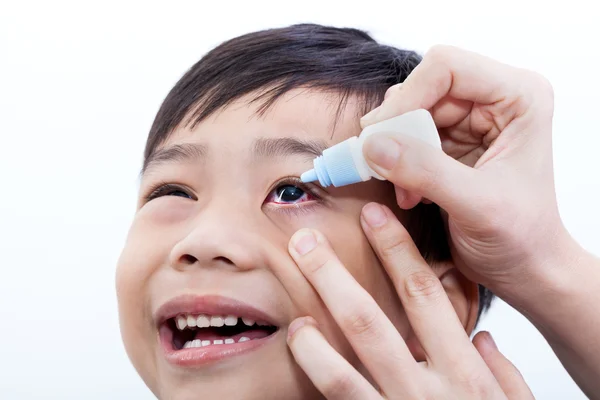 Closeup of parent pouring eye drops in eye her son — Stock Photo, Image