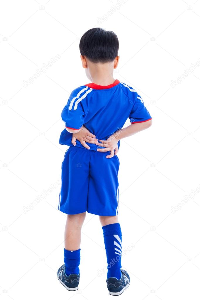 Back pain. Child rubbing the muscles of his lower back