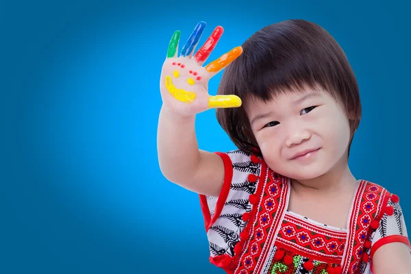 Adorable little asian (thai) girl painting her palm, on blue bac — Stock Photo, Image