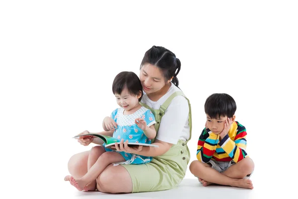 Mother with her child, daughter reading a book, son feel bad (di — Stock Photo, Image