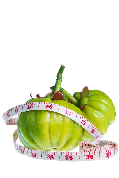 Garcinia cambogia met meetlint, geïsoleerd op witte backgro — Stockfoto