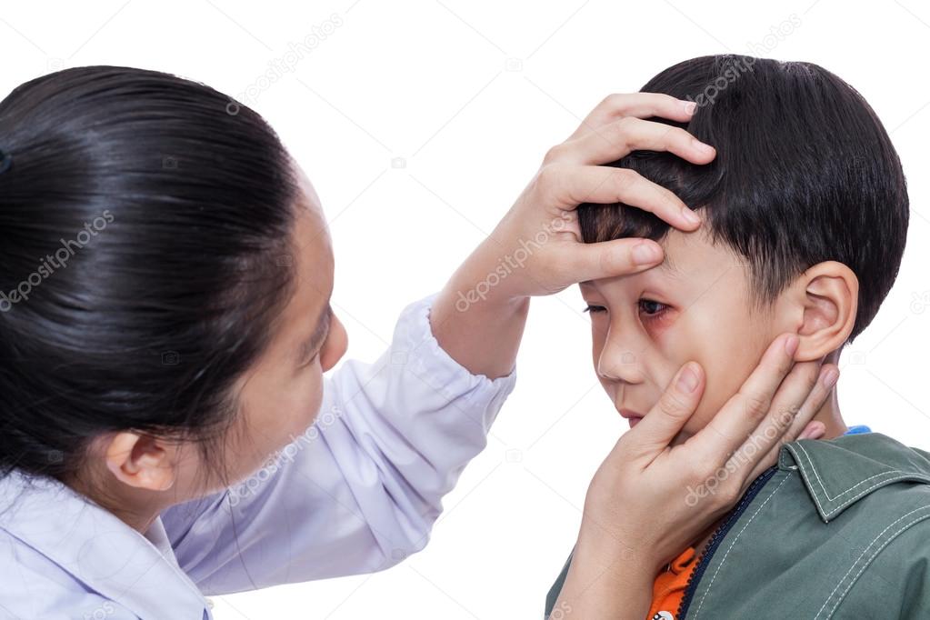 Boy with an injured eye. Doctor examining and first aid a patien