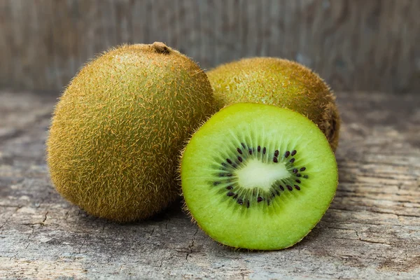 Close up fresh kiwi fruit on old wood background.