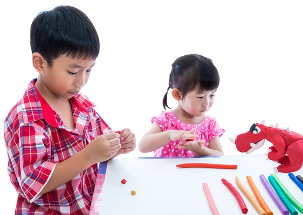 Asian kids playing with play clay on table. Strengthen the imagi — Stock Photo, Image