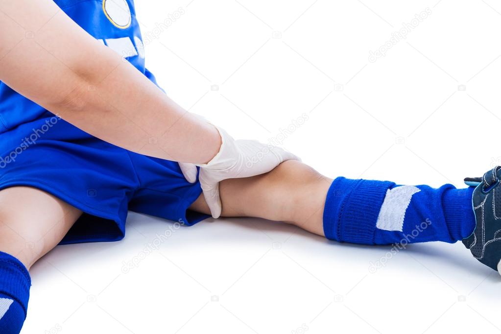 Sports Injury. Doctor First Aid At Thigh Of Soccer Player. Isolated On White.