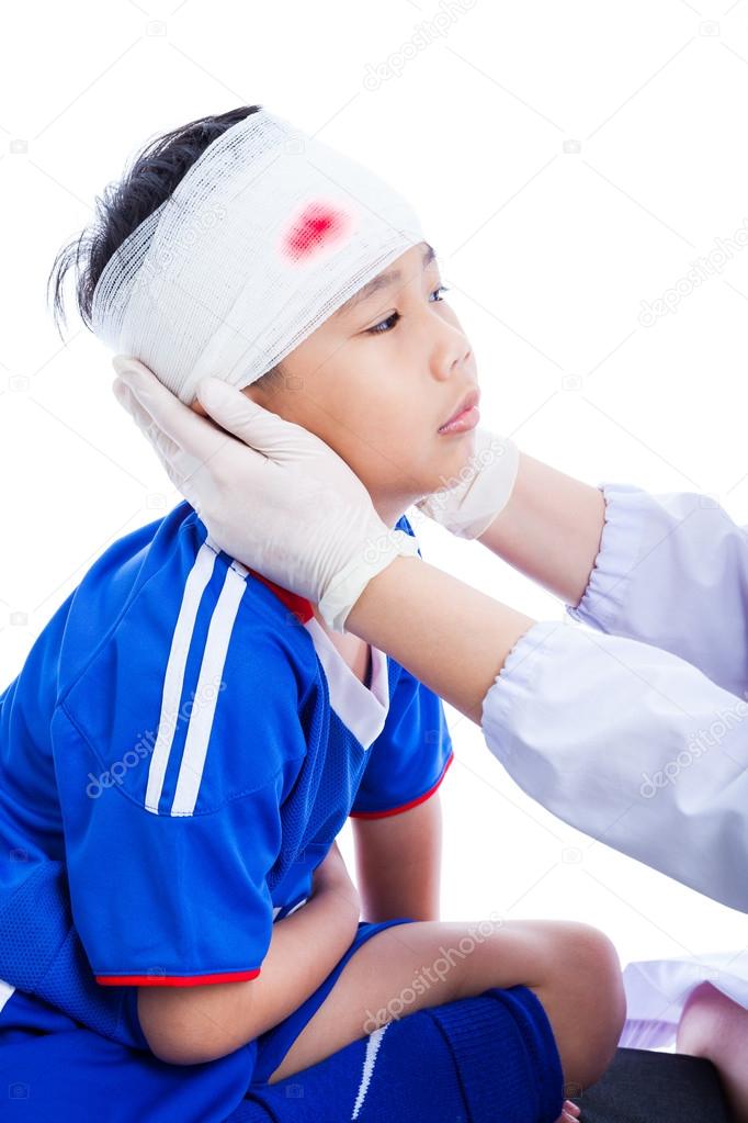 Sports injury. Doctor makes a bandage on head patient, on white.