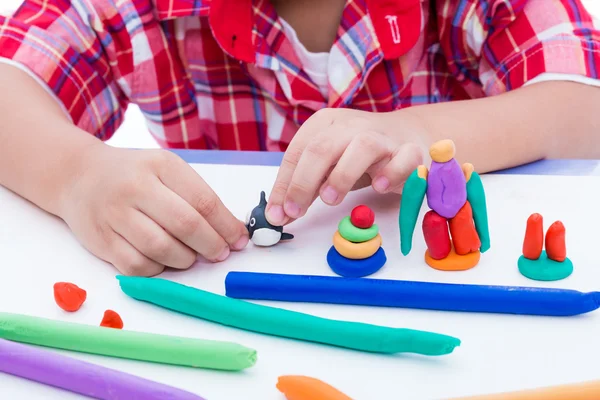 Close up child's hand moulding modeling clay. Strengthen the imagination of child. — Stock Photo, Image