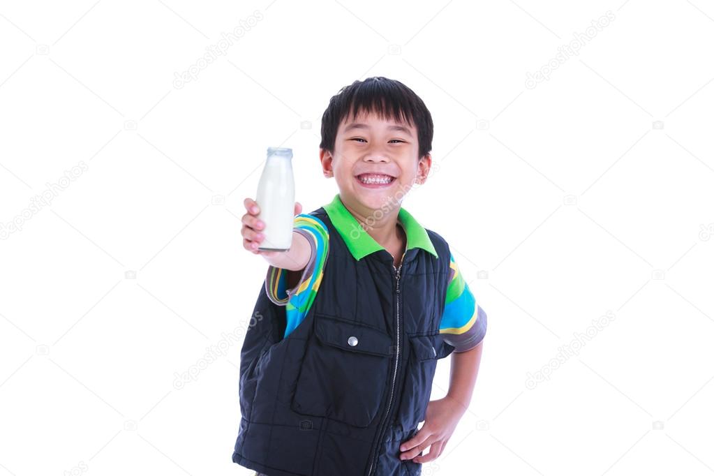 Boy smiling and showing bottle of milk, on white. 