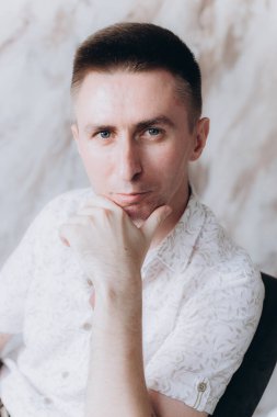 Şık bir adam, model, şık şortlu ve atölyede bir gömlek, yaz modası.