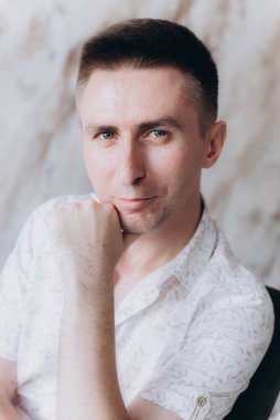 Şık bir adam, model, şık şortlu ve atölyede bir gömlek, yaz modası.