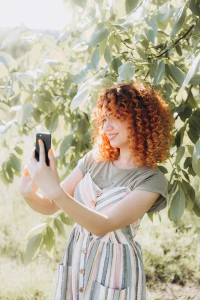 Redhead Flicka Med Afro Lockar Med Telefon Grön Park Gör — Stockfoto