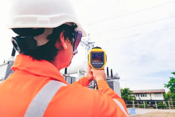 Electrical engineers used a thermometer to check for faults in equipment sets, Also known as preventive maintenance to reduce the damage of equipment, Concept to professional engineer on industrial.