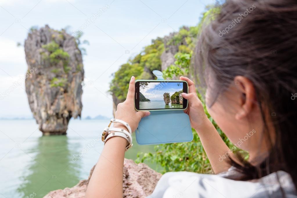 Women tourist shooting natural view by mobile phone