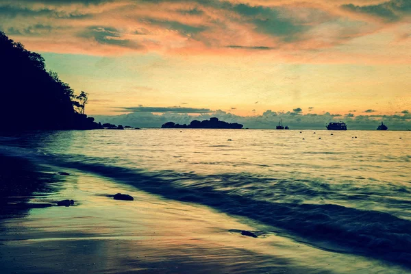 Vintage stylized photo of sunrise on the beach — Stock Photo, Image