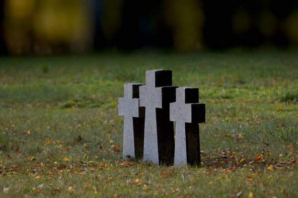 Three Catholic crosses made of granite stone, installed in the places of an ancient burial place.