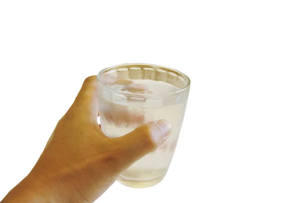 Stock Photo hand holds clear water in glass isolated on white background — Stock Photo, Image