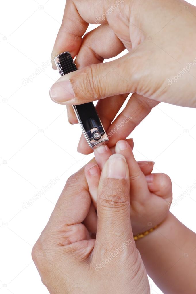 Stock Photo A Mother cuts fingernails of a Baby