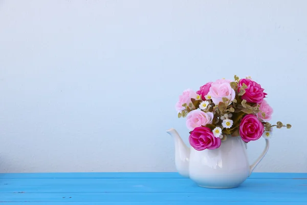 Foto D'archivio Mazzo floreale di plastica di fiori diversi su sfondo blu tavolo — Foto Stock