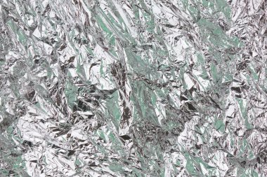 Abstract crumpled silver aluminum foil closeup background textur clipart