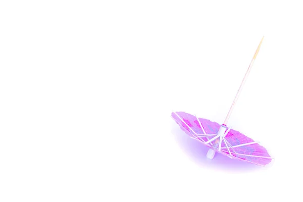 Pink cocktail umbrella on white background — Stock Photo, Image